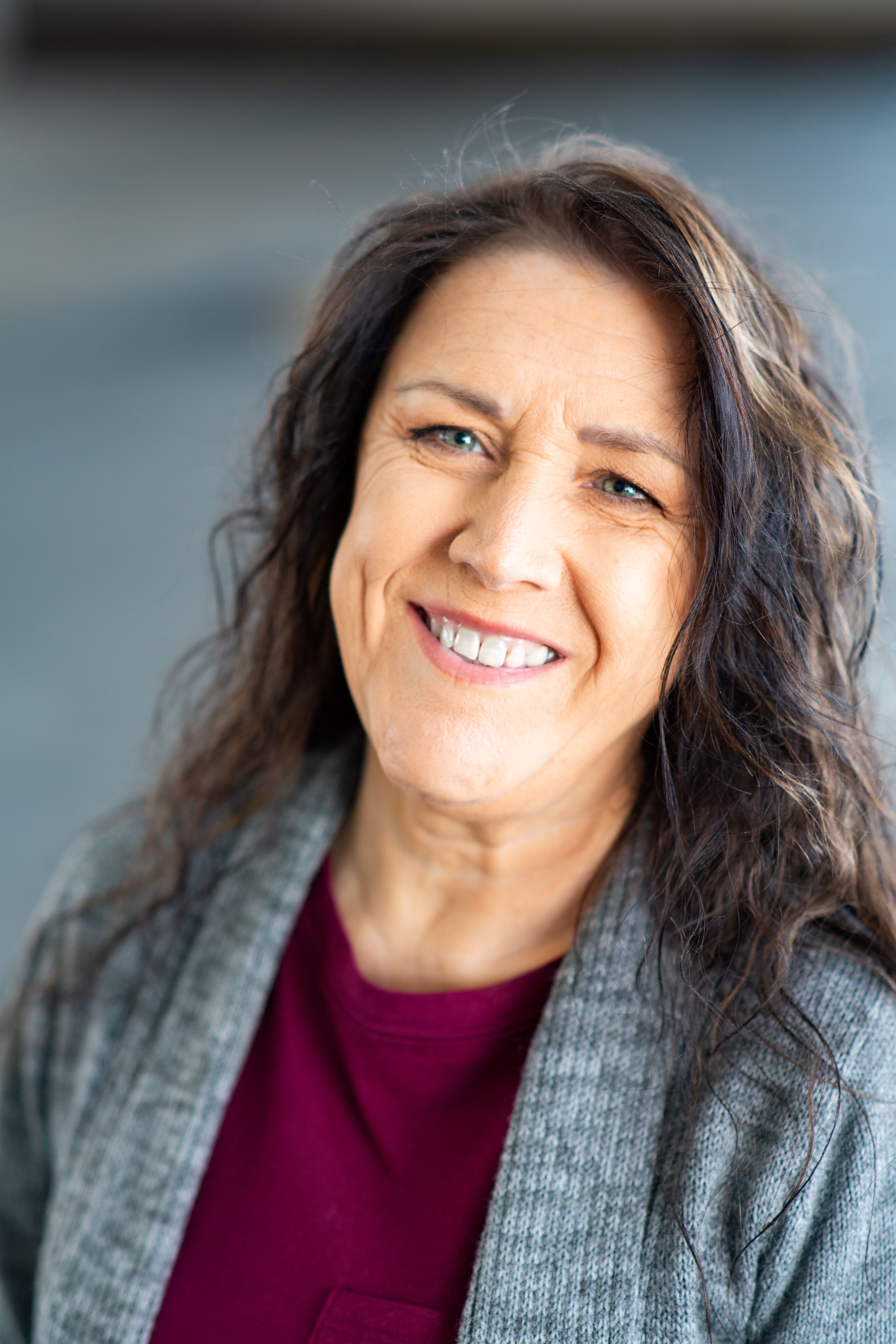 Eva Gehlert smiling in a gray cardigan