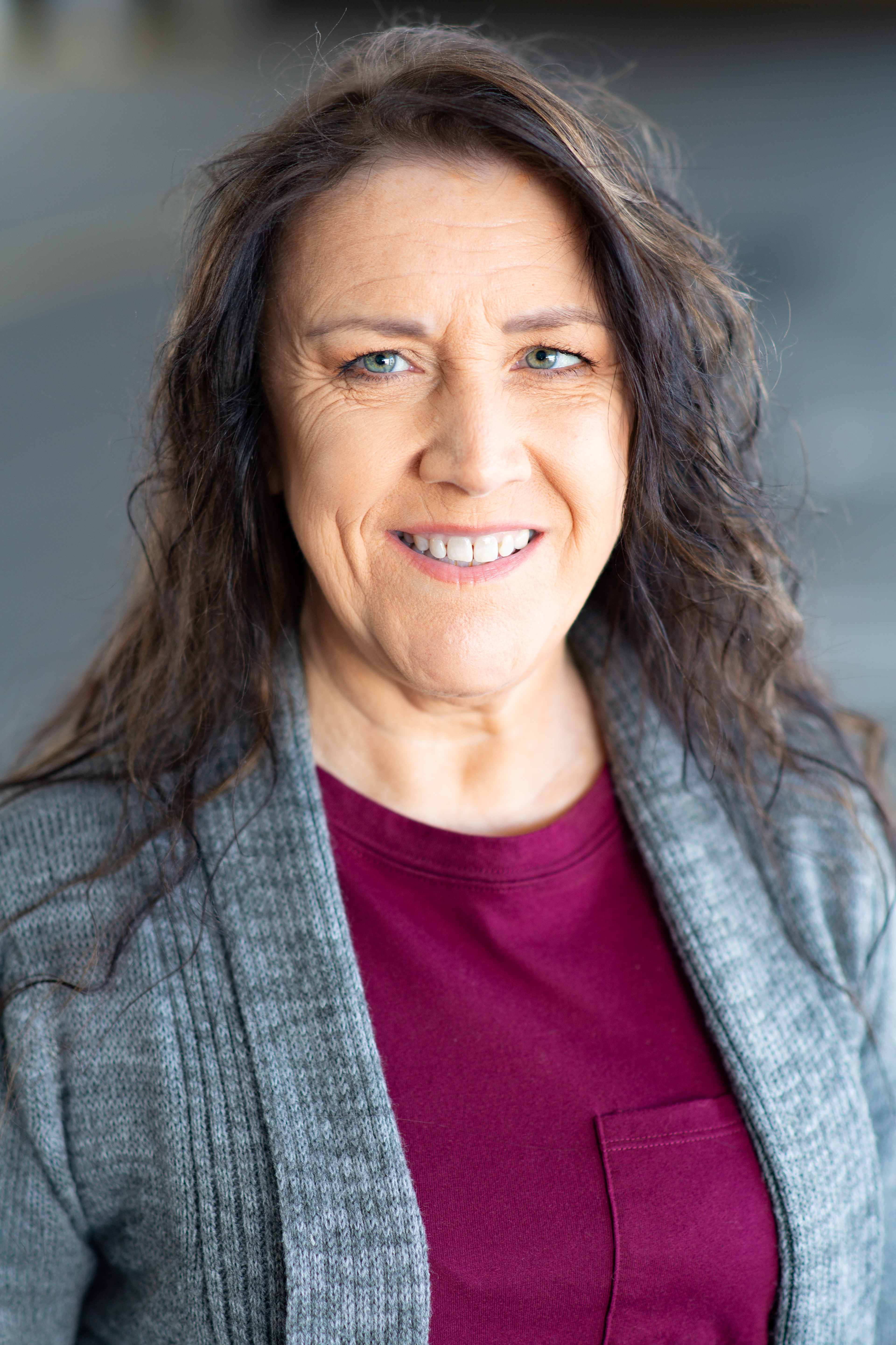 Eva Gehlert smiling in a gray cardigan
